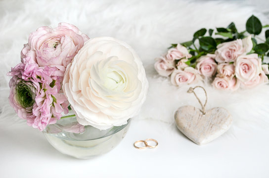 Wedding composition. A gentle picture for a story or a blog. Pink roses, heart and fluffy rug. Flat lay. Copy space.