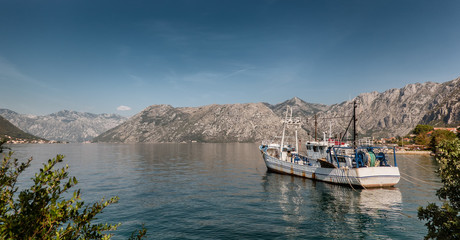 Fototapeta premium Kotor bay coastline with fishing vessel in Montenegro