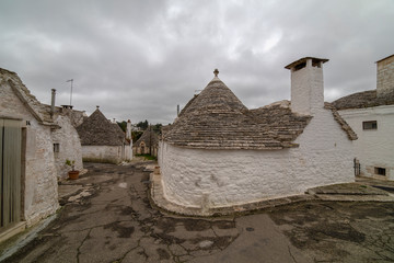 Fototapeta na wymiar ALBEROBELLO, APULIA, ITALY - FEBRUARY 03 - Beautiful view of the traditional trulli houses with their conical roof on february 03, 2019 