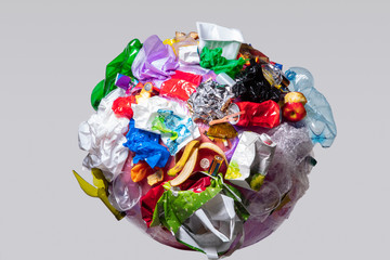 A globe of the earth with trash over white background, the concept of ecology problem and World...