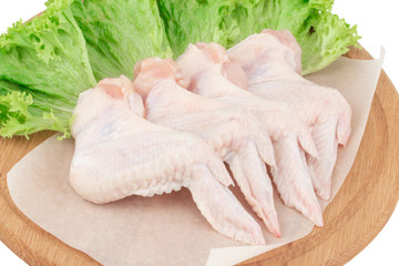 Raw chicken wings on wooden cutting board