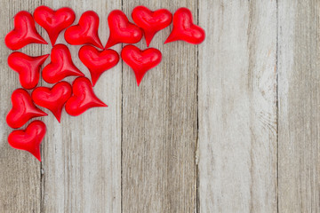 Red hearts on a weathered wood background