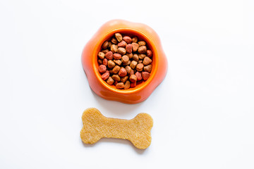 dry dog food in bowl on white background top view