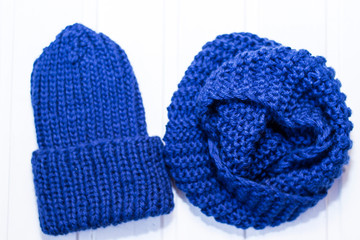 Knitted woolen hat and scarf. Blue yarn