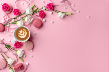Pink macarons with pearls, coffee and white roses for womens day on a cleare pink background with blank space for design elements and text