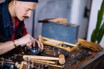 master working with gold and other precious metals, close up side view photo