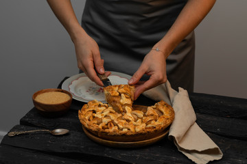 homemade apple pie, female hands, serving a slice of cake, homemade, rustic style