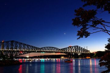 Fototapeta na wymiar The Pont du Quebec and the St Lawrence River at dusk as seen from Parc de la Marina-de-la-Chaudière, St-Romuald