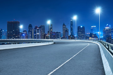 Fototapeta na wymiar High speed corner overpass asphalt road with Bangkok cityscape , night scene .