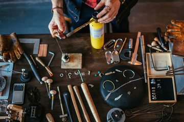 guy turing on the gasoline burner at workplace. close up cropped photo