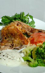 traditional fried chicken with vegetables sauce and greens