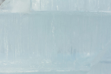 Naklejka na ściany i meble Ice bricks with bubbles of air inside. Abstract ice crystal texture. Clear ice background.