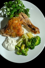traditional fried chicken with vegetables sauce and greens