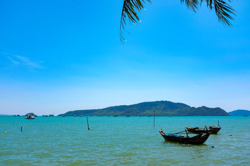 Fototapeta na wymiar Long tail boat on the beach in Phuket Thailand