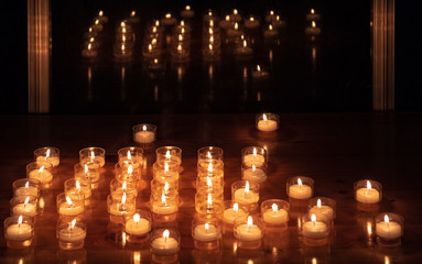 Candles on a table next to a window