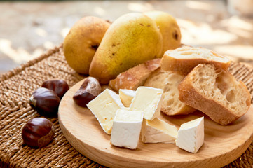 Cheese plate: brie, pears, walnuts, honey, baguette bread