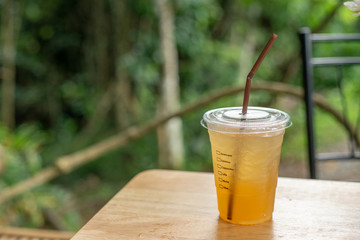 Ice lemon tea in clear glass with nature background
