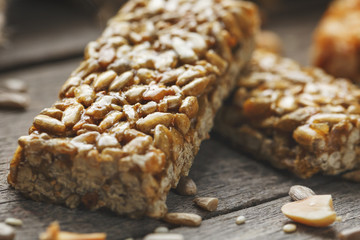 Casinac from sunflower seeds on old vintage background with burlap cloth. Country style. Delicious sweets from seeds of sunflower, sesame and peanuts, covered with shiny glaze