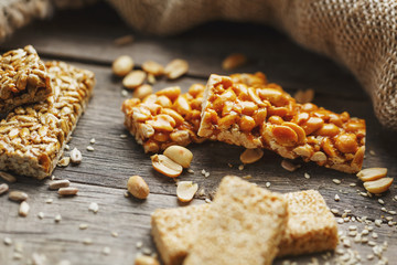 Casinak made from peanuts, on old vintage background, with burlap cloth. Country style. Delicious sweets from seeds of sunflower, sesame and peanuts, covered with shiny glaze