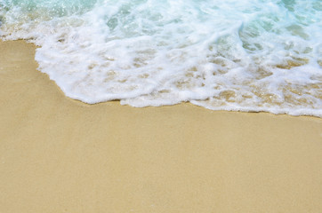 Fototapeta na wymiar Sand and wave sea with copy space