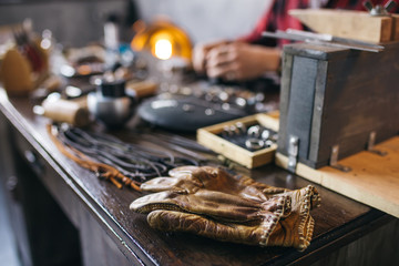 focus on the gloves. blurred image, working craftsman in the background of the photo