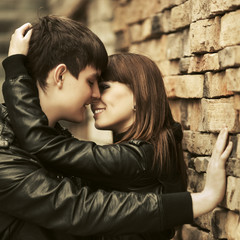 Happy young couple in love embracing on city street