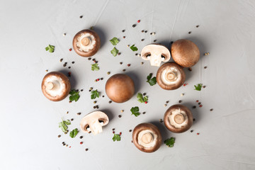 Obraz na płótnie Canvas Flat lay composition with fresh champignon mushrooms on grey background