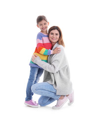 Happy woman and daughter in stylish clothes on white background