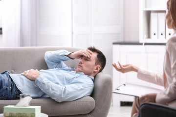 Fototapeta premium Psychotherapist working with young man in office