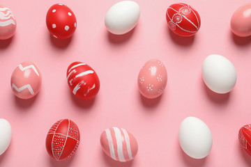 Flat lay composition of painted Easter eggs on color background