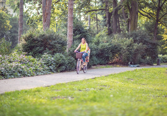 mother and son on bicycles in park.
