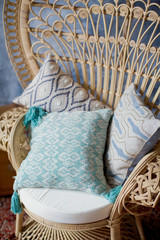 Obraz na płótnie Canvas pillows on peacock chair