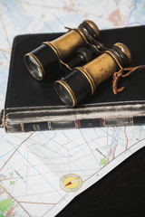 Ancient binoculars lie on book