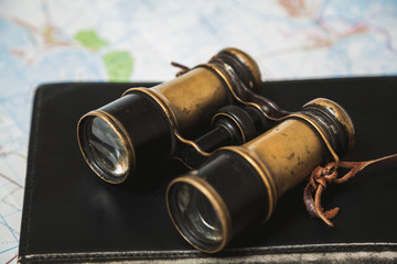 Ancient binoculars lie on book