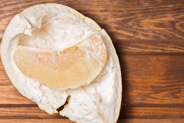 peeled citrus fruit Pomelo on a wooden background