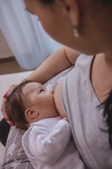 Obraz na płótnie Canvas Mother naturally breastffeding one month old toddler 