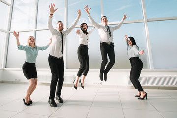 happy business team having fun in an empty new office.