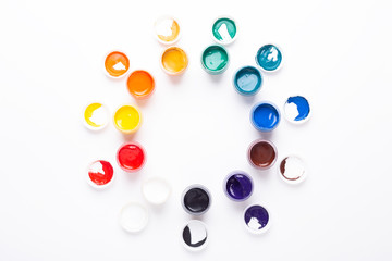 Multicolored gouache on a white background Circle shape Isolated Paints in containers Top view