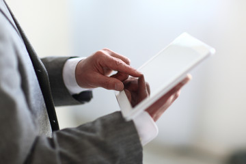 close up.the businessman's hand presses on the screen of a digital tablet.photo with copy space