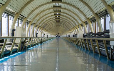 long corridor of connecting the buildings in the airport.