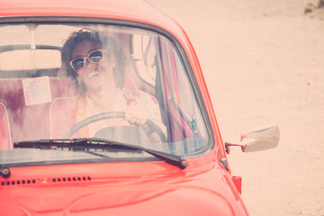 Cheerful happy lady caucasian middle age curly female smile and laugh driving her old retro...