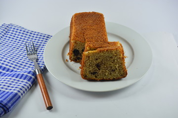 slice of cake on a white plate on a white background