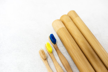A family set of wooden bamboo toothbrushes on white background
