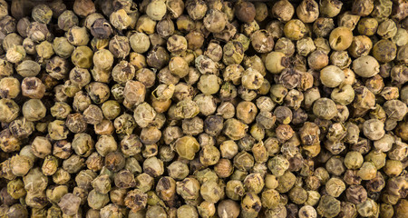 green pepper peppercorns background. Natural seasoning texture.
