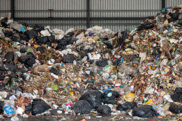 A pile of garbage in a waste storage area at a waste sorting plant