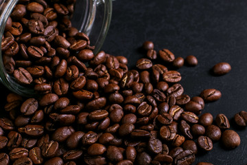 The can of coffee is turned upside down, with scattered beans. Macro copy space.