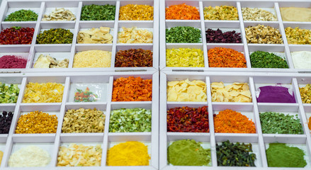 Dried vegetables in wooden box, onions, beets, carrots, pumpkin, bay leaf. Superfoods, herbs.