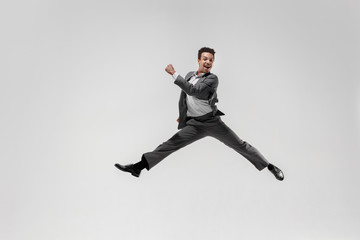 Fototapeta na wymiar Happy businessman dancing in motion isolated on white studio background. Flexibility and grace in business. Human emotions concept. Office, success, professional, happiness, expression concepts