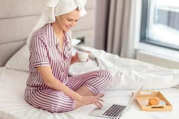 cheerful girl laughing at funny news from the net. side view photo