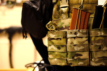 Soldier with camouflage bulletproof vest and Machine gun. Close up. mock up. Toned sepia